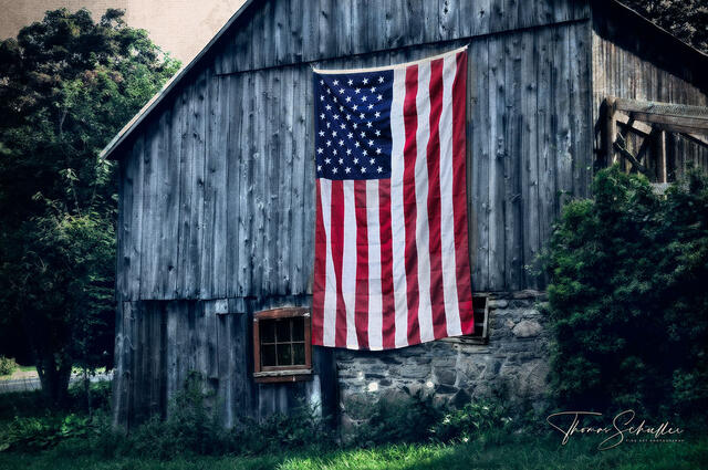 a nostalgic artwork of a rustic barn adorned with a large American flag on a western Connecticut hillside | Old barn fine art prints by Thom Schoeller 