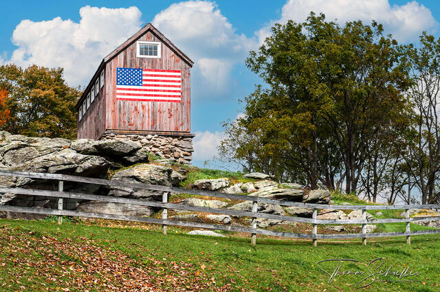 A tiny rustic barn adorned with a painted American flag overlooks the Litchfield Hills from it's Roxbury Connecticut Perch | Connecticut landscape photography
