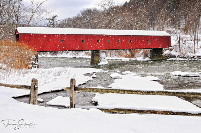 Idyllic New England scene featuring the Red Covered bridge of West Cornwall Connecticut during a picturesque snowfall | Connecticut fine art photography