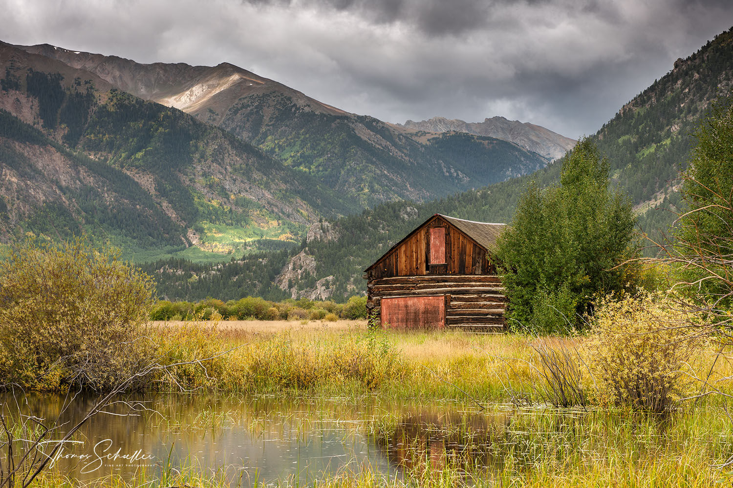 An old rustic barn next to a small pond along the historic Independence Pass route through the heart of Colorado's Rocky Mountains | Fine Art Prints